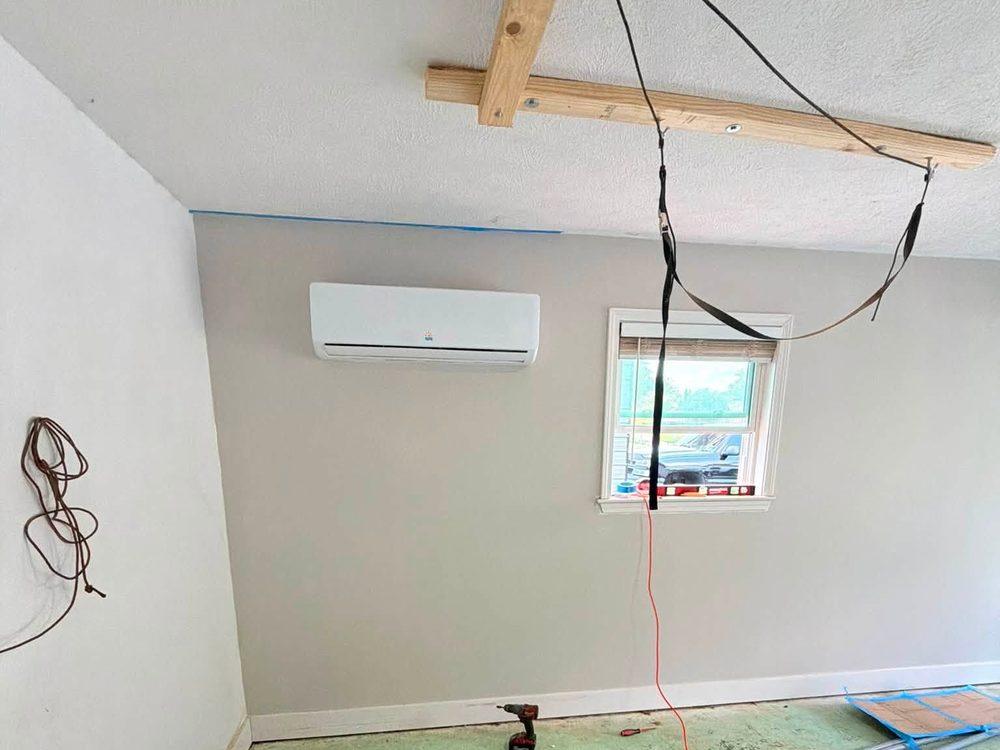 Ductless mini-split installed high on a garage wall